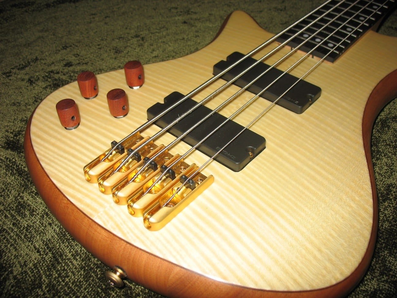 Five-string bass with a flamed maple top and gold hardware
