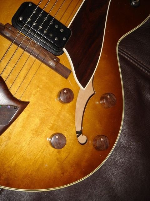 Sunburst archtop guitar with f-hole and wooden knobs