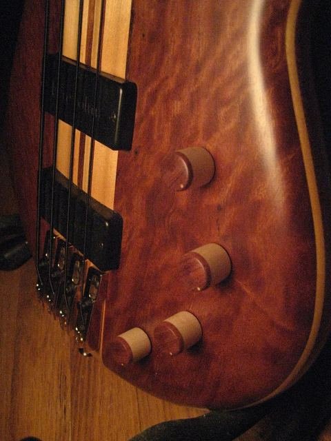 Close-up of a figured bass body and pickups