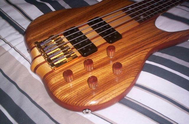 Striped hardwood bass with wooden knobs, angled view