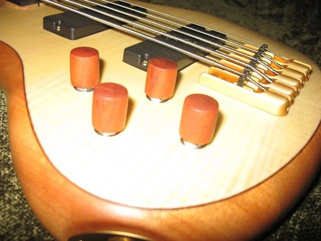 Wooden knobs installed on a maple bass
